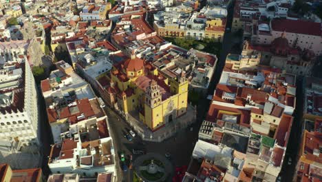 aerial circling view of guanajuato city center, mexico: basilica of our lady of guanajuato and university