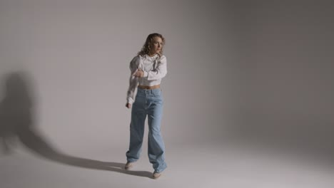Full-Length-Studio-Shot-Of-Young-Woman-Having-Fun-Dancing-Against-Grey-Background-2
