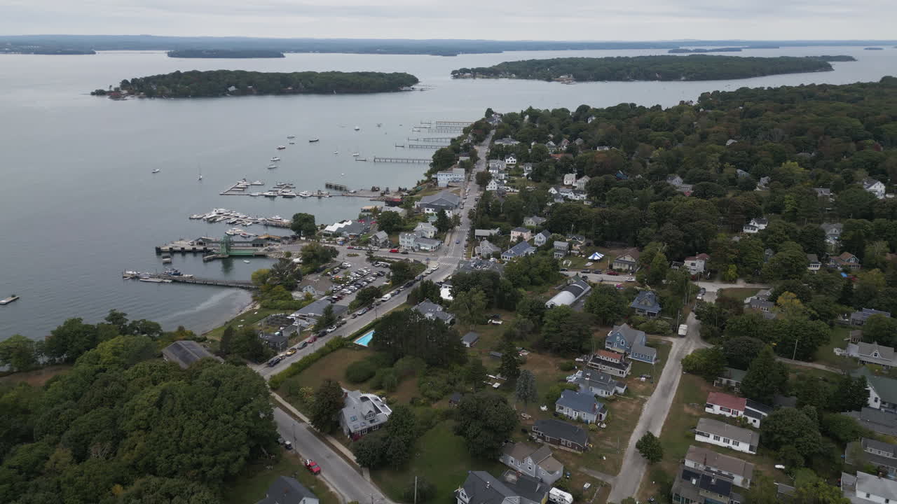 Peaks island in portland, maine, showcasing coastal town, harbor, and surrounding water , aerial view
