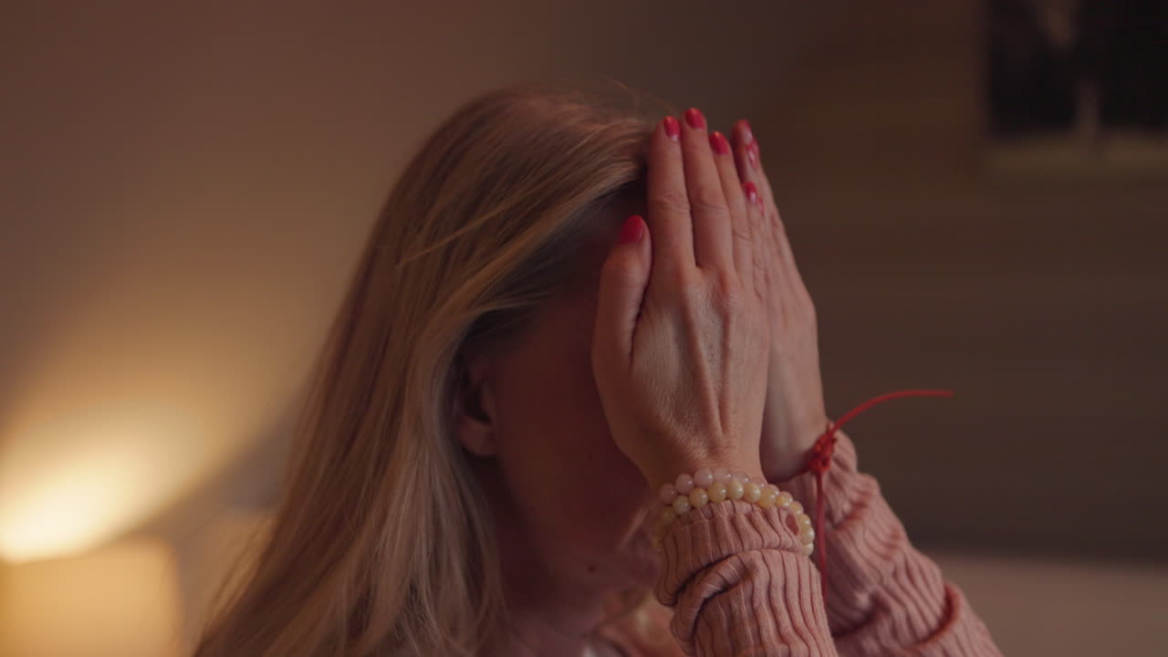 Woman Covering Face with Hands