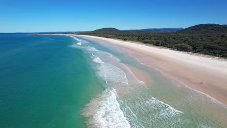 foamy waves with golden sand at cabarita beach in northern rivers, new south wales, australia