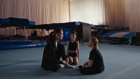 young gymnasts training with their coach in a gym