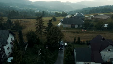 aerial shot of trucks convoy on narrow road