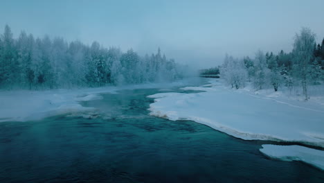 vikakongas river flowing through snowy forest at winter in finland