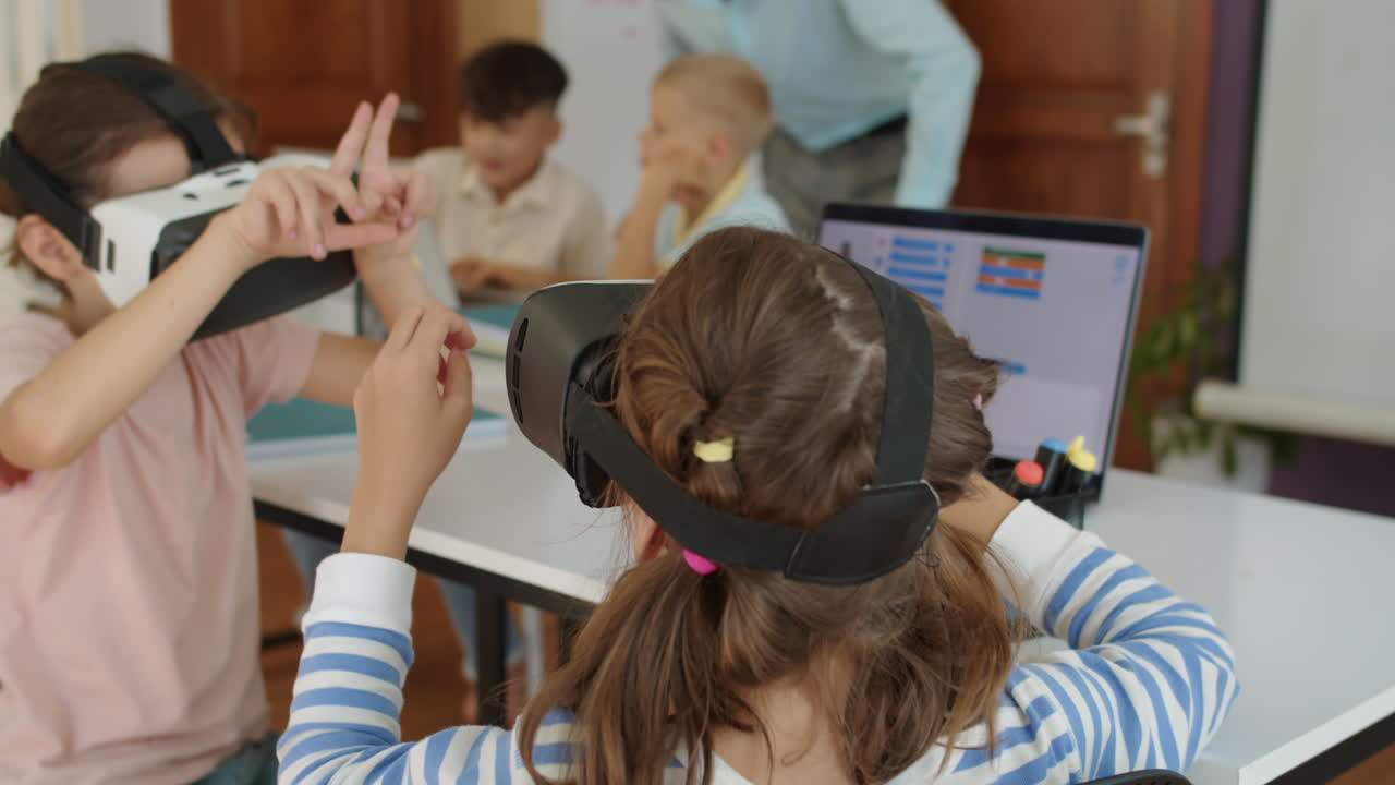 Girls Using VR Glasses during Group Computer Class at School