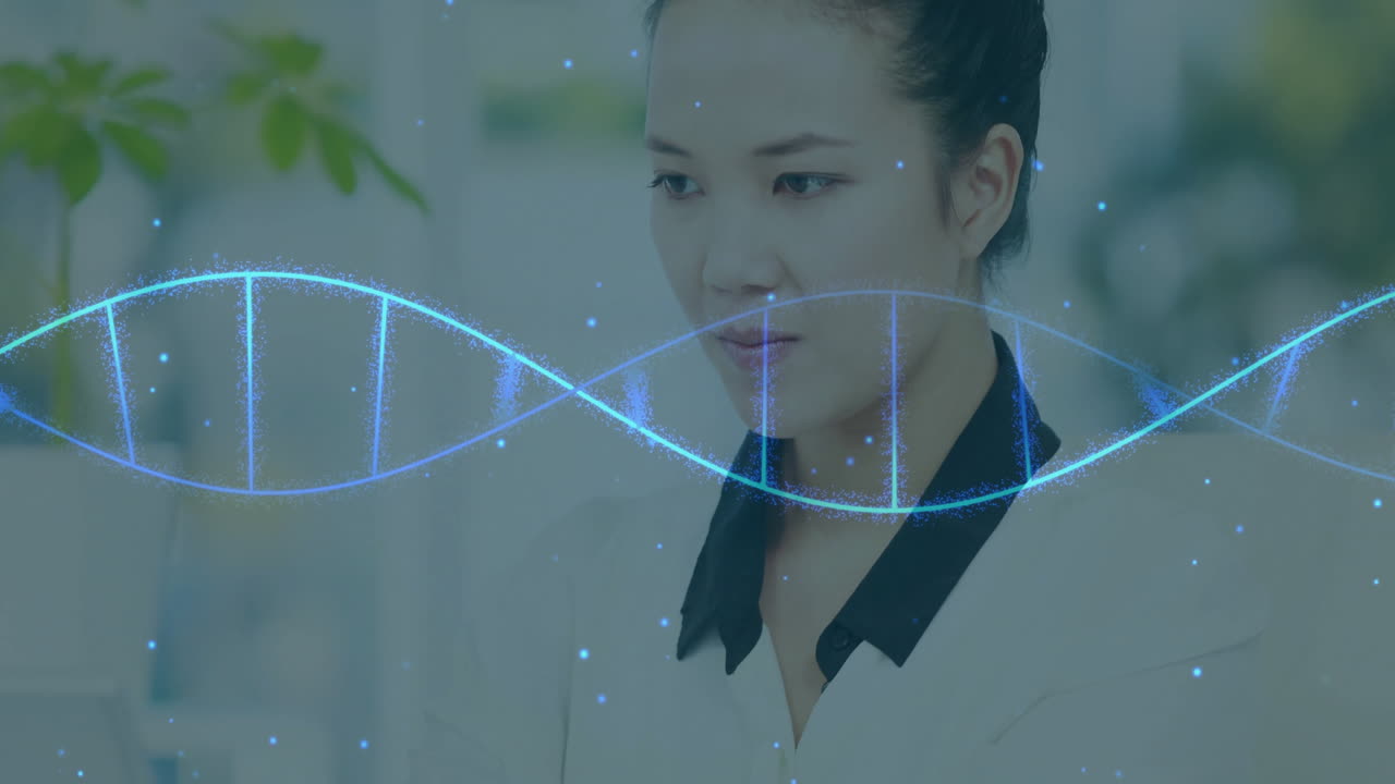 DNA strand animation over focused woman working at office desk