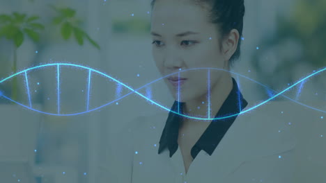 dna strand animation over focused woman working at office desk