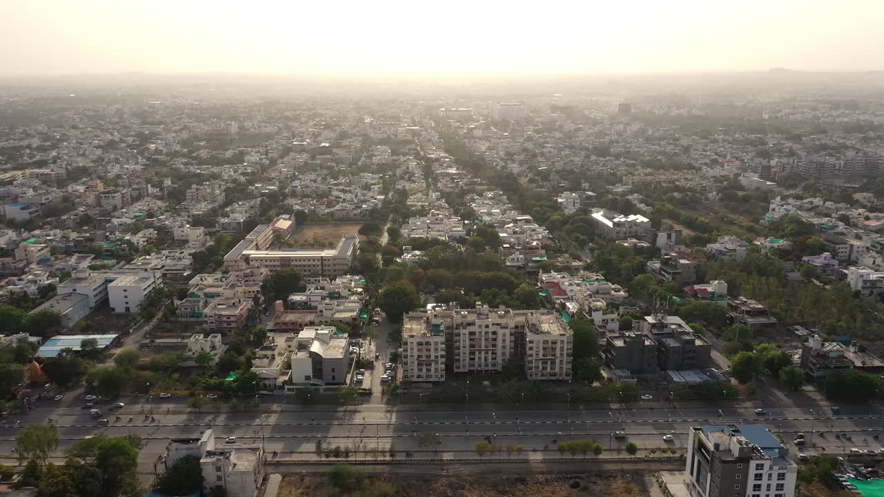 The Beautiful City Of Indore With Vehicles Travelling On The Road On A Sunrise In India. - aerial drone shot
