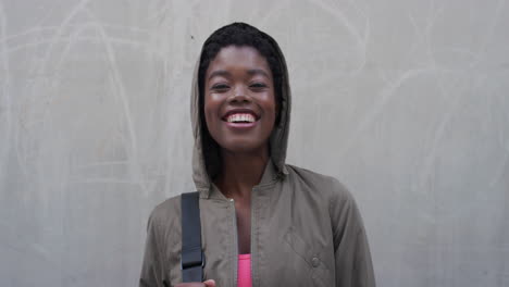 portrait beautiful young african american woman smiling happy wearing hood enjoying independent urban lifestyle real people series