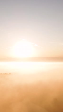 golden sunrise or sunset over a misty landscape