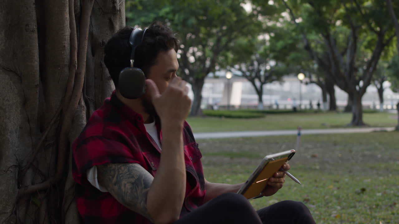 Man relaxing in park with headphones