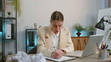 angry furious woman working at home office throwing crumpled paper, having nervous breakdown at work