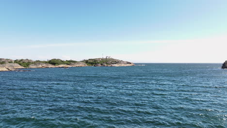 Distant-View-Of-Stavernsodden-Lighthouse-Across-The-Sea-In-Larvik,-Vestfold-og-Telemark,-Norway