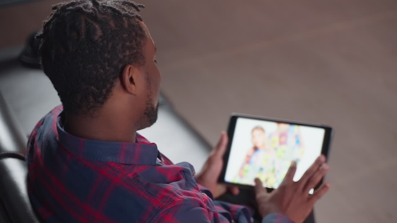Man using tablet to view a family photo