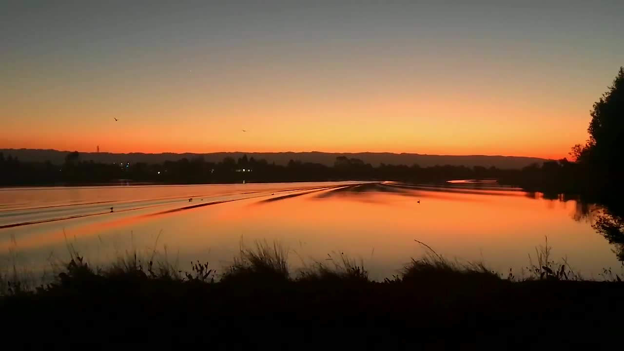 A slow motion video of a beautiful twilight sky reflecting off a lake in Mountain View, California