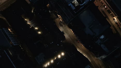 topdown drone shot at night over leeds city centre streets and buildings near the headrow