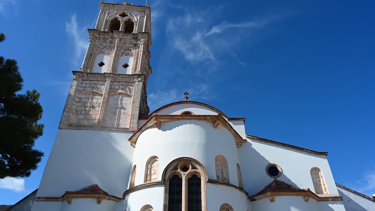 Close up of the apse and stone details of the Church of the Holy Cross in Pano Lefkara, Larnaca District, Cyprus with the blue sky on the background
