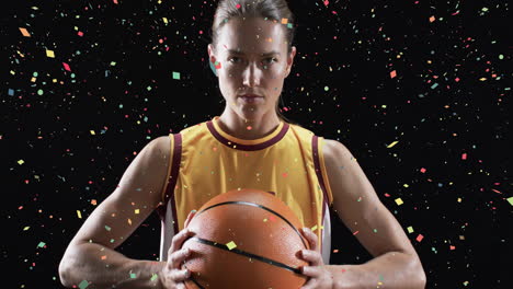 animation of confetti falling over caucasian female basketball player on black background