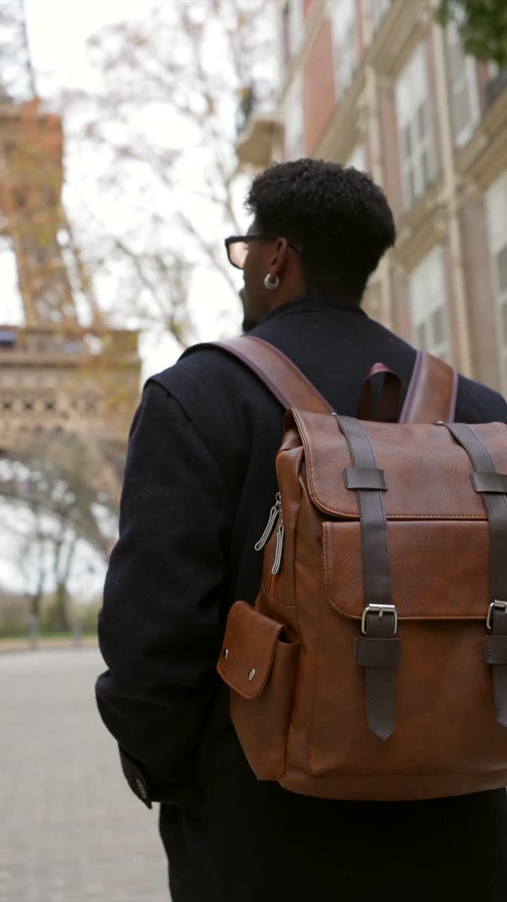 Man with Backpack in Paris near the Eiffel Tower