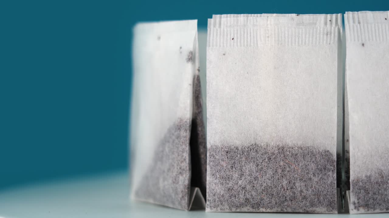 Motion around circle of tea bags standing on blue background