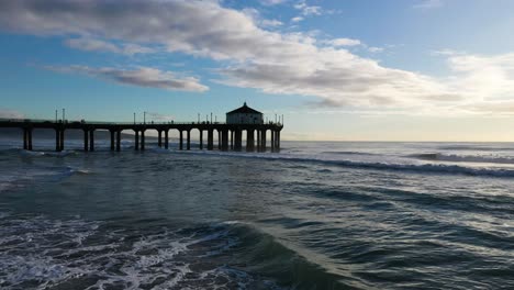 Drone-shot-flying-over-the-Manhattan-Beach-Pier-and-Pacific-Ocean-in-California