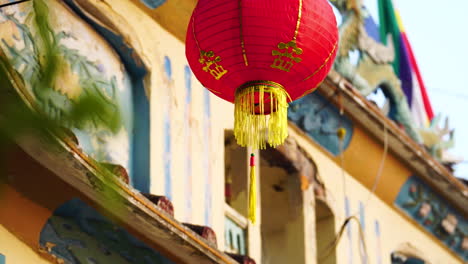 red chinese lantern hung outside a building in phan thiet, vietnam at daytime