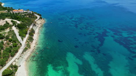 navagio beach with turquoise seascape in greece - aerial drone shot