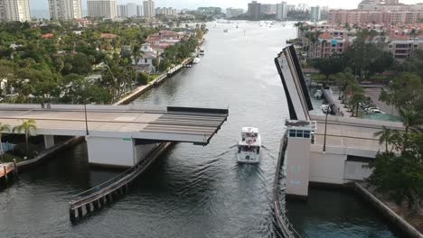 aerial of big boat driving under a bridge