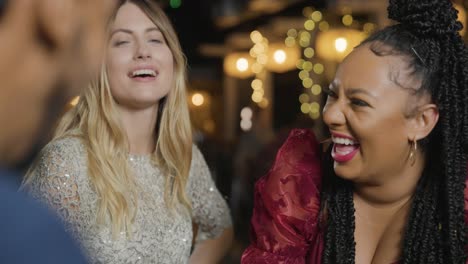 tracking shot of friends talking and laughing at a bar