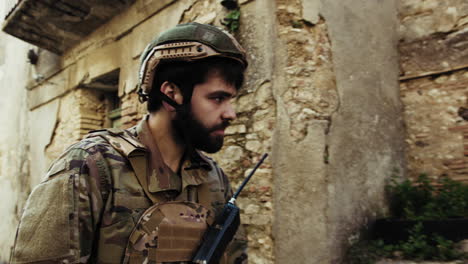 soldier walks in a war destroyed village houses