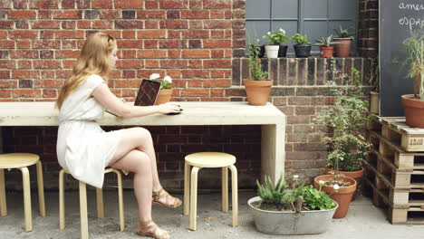 Beautiful-woman-drinking-coffee-working-in-cafe