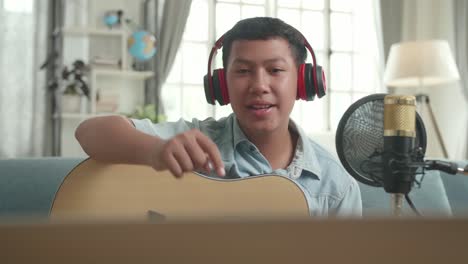 teenager singing and playing acoustic guitar