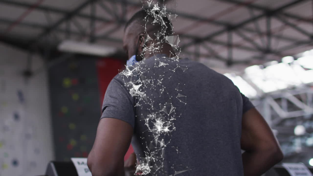 Man running on treadmill inside gym, with animated network overlay visualizing motion data