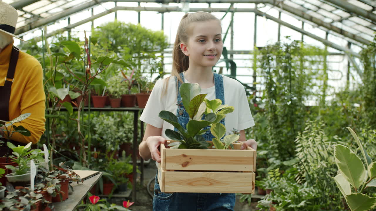 Mother and Daughter Gardening in Greenhouse
