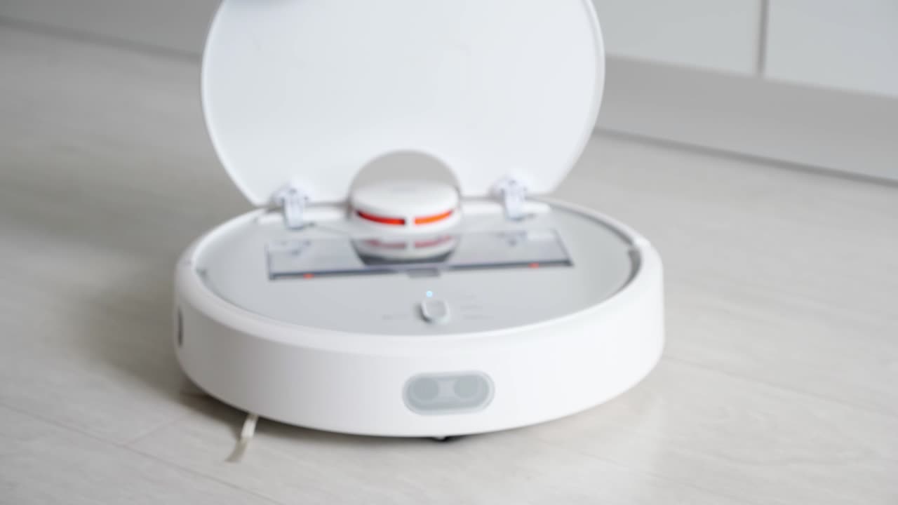 Woman opens robot vacuum cleaner show container with rubbish