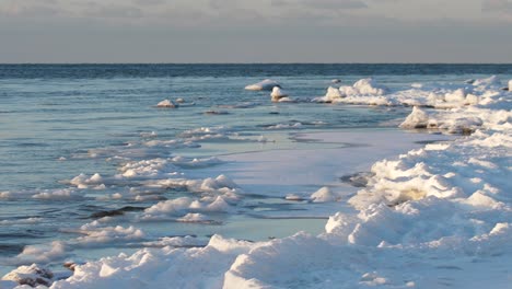 in the winter, stones are icy on the sea shore