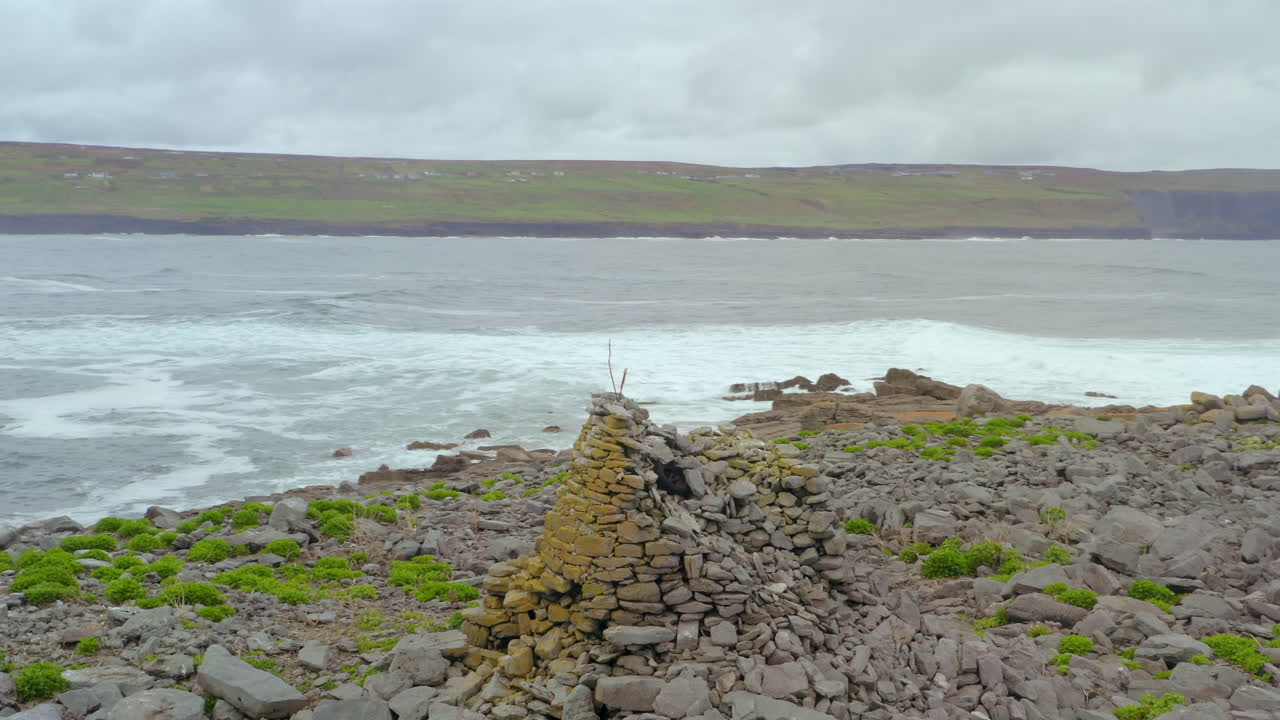 Slow motion aerial orbit showing Cliffs of Moher and Crab Island in the foreground