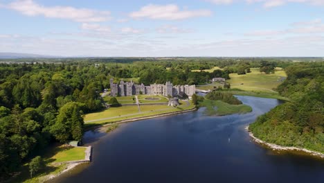 an orbital drone shot of ashford castle in ireland