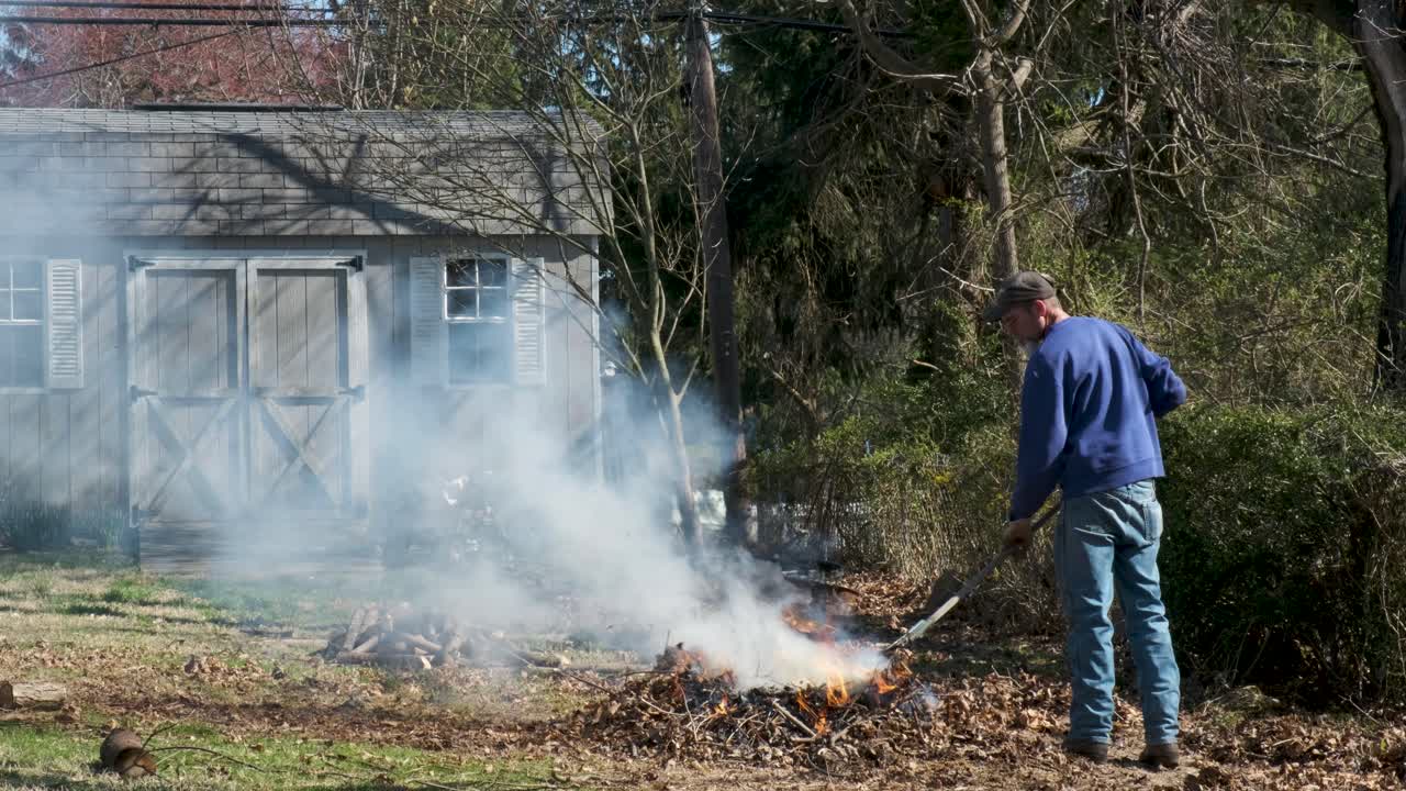 뒤뜰 모닥불에 나뭇잎을 긁어모으기