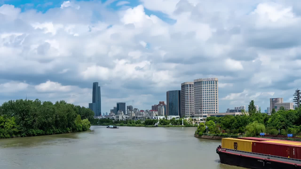 Cityscape with River and Cargo Ships on a Cloudy Day