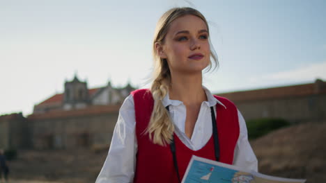 calm tourist holding map outdoor closeup vertical. young girl walking searching