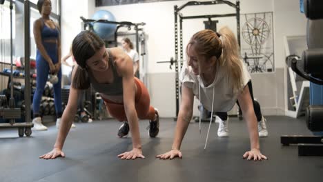 women high fiving during plank exercise