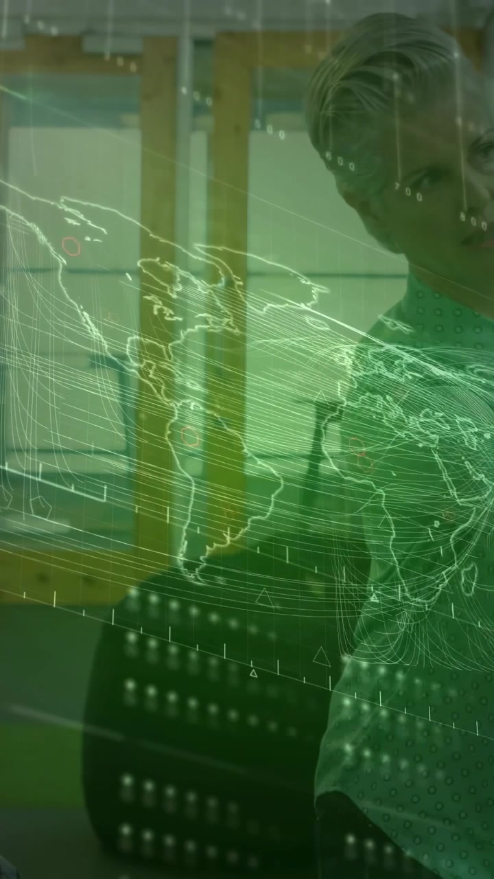 Vertical video: Analyst leaning and gesturing at glass, updating green map overlay for analytics