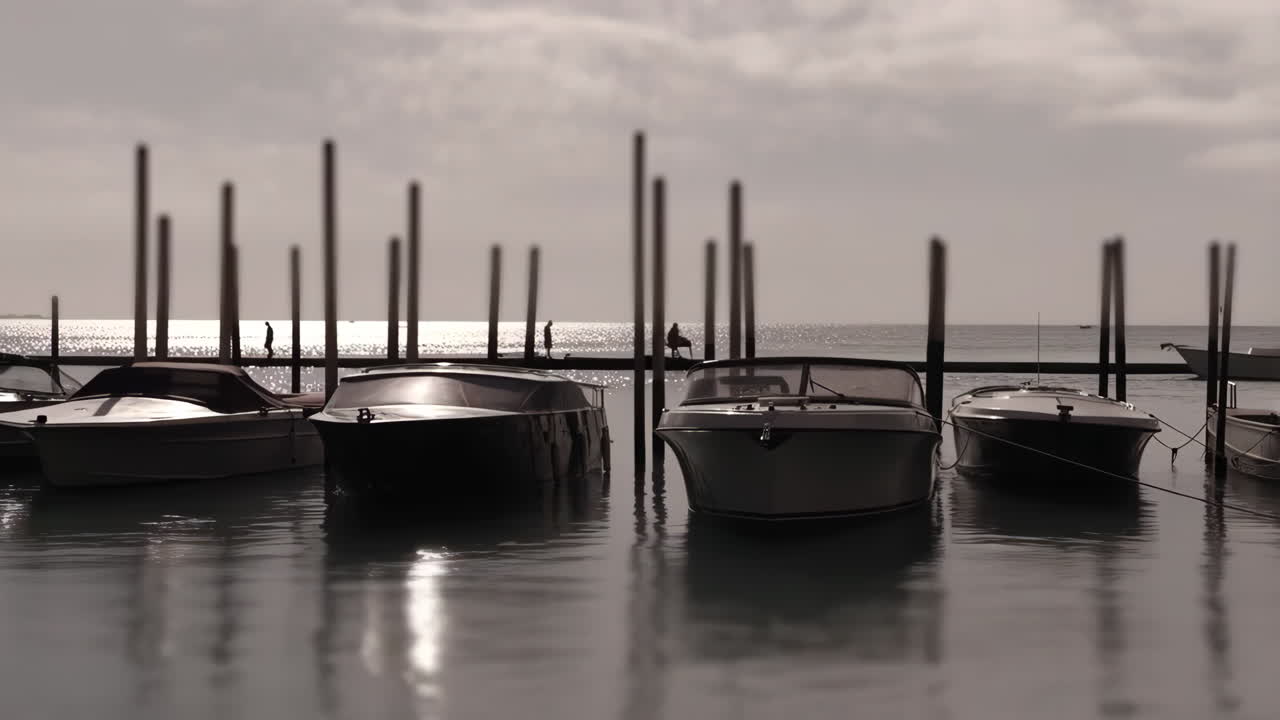 Både fortøjet i en marina ved solnedgang med refleksioner på vandet.
