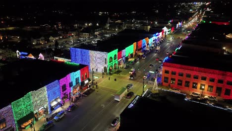 rochester, michigan skyline at night lit up with christmas lights on buildings and drone video circling close up