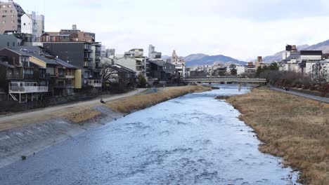 time-lapse of a river flowing through a cityscape