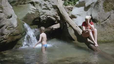 family enjoying a summer day at a scenic waterfall