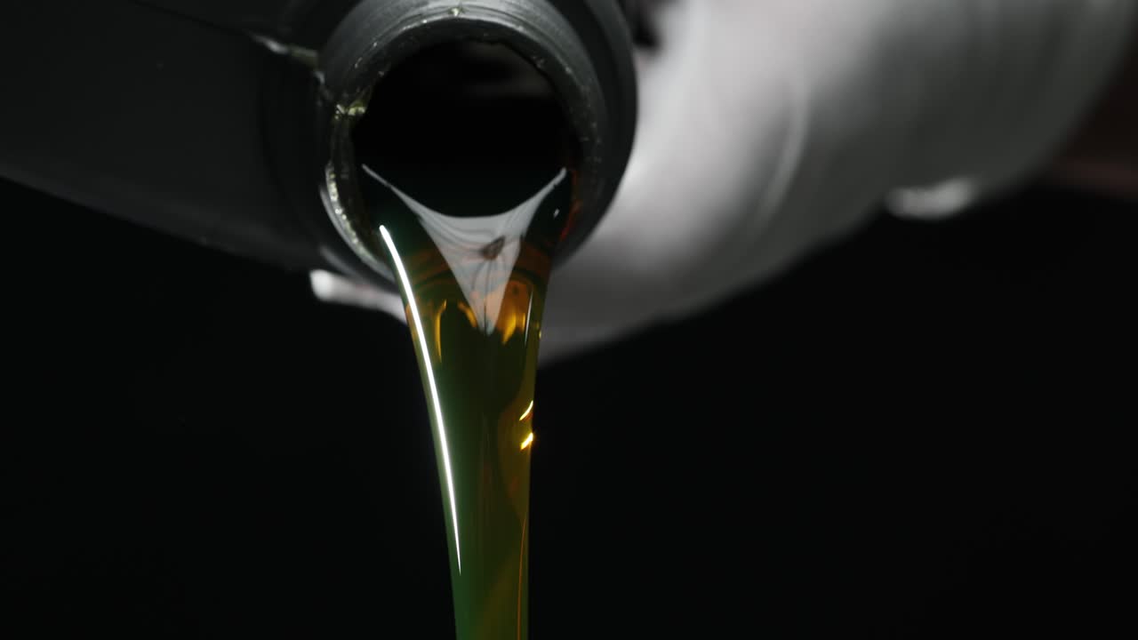 Close-up of oil being poured from a bottle