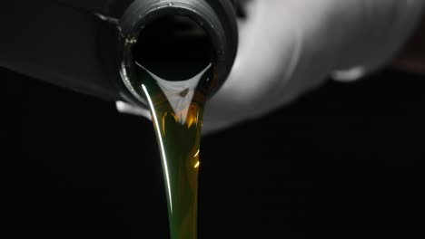 close-up of oil being poured from a bottle