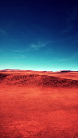 a red desert under a blue sky